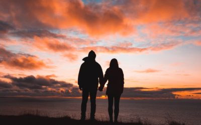 Couple holding hands in sunset | CFHP